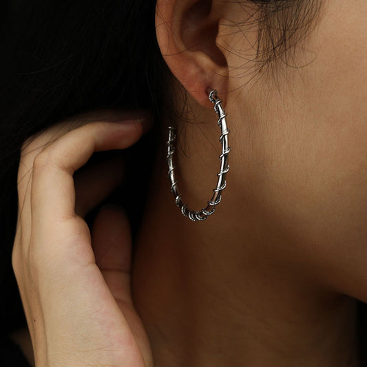 ELNA Silver Hoop Earrings with a Decorative Twist