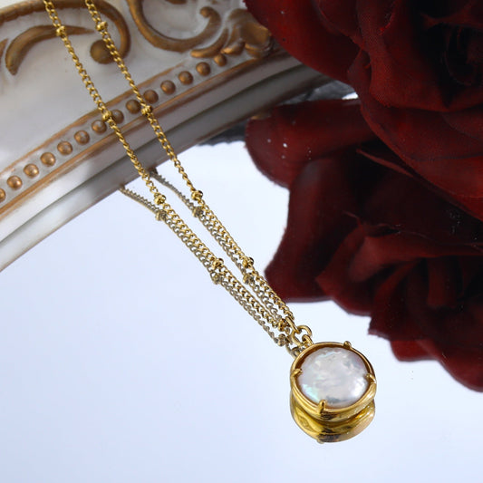 LERATI: Beaded Chain with an Encased Fresh Water Pearl Pendant in Gold