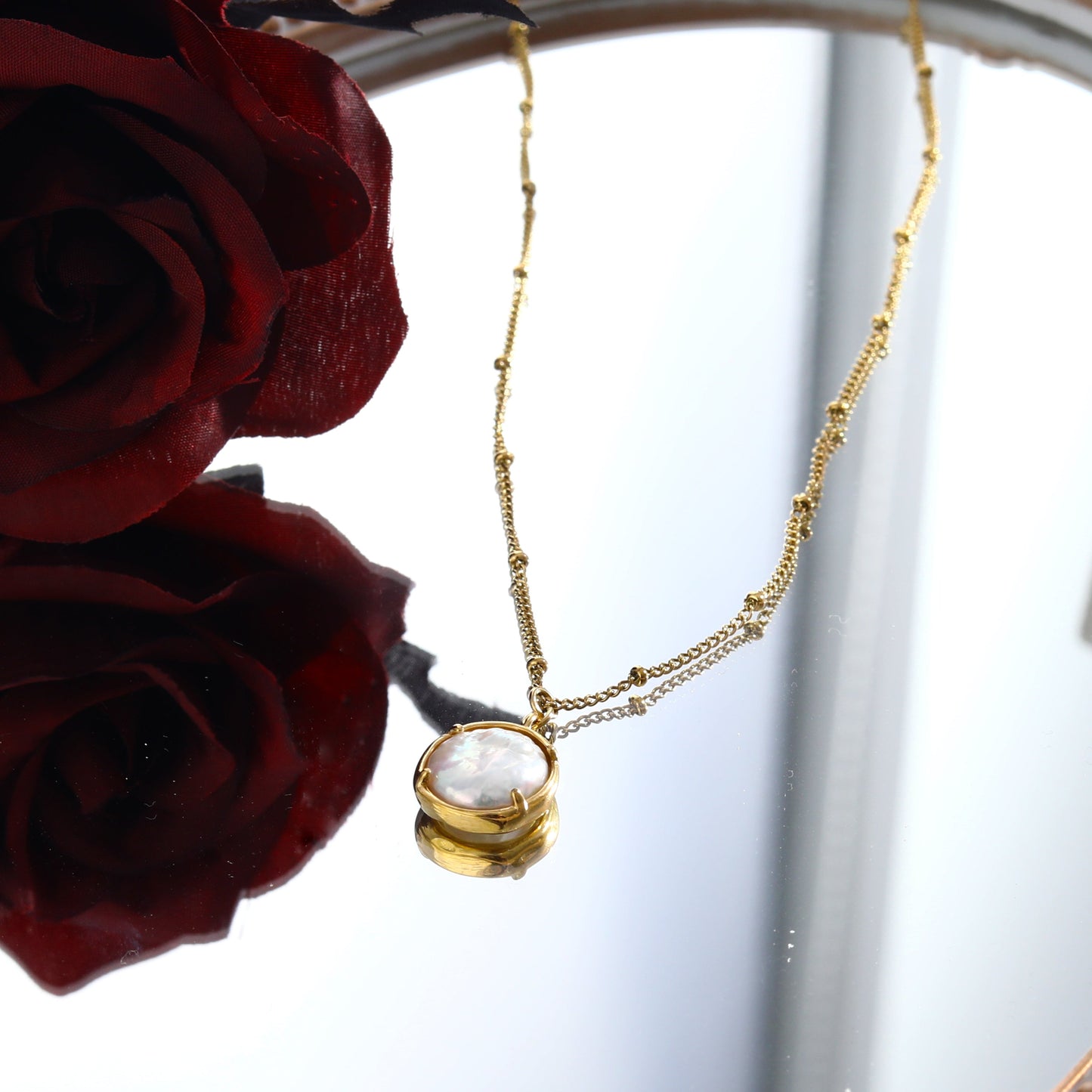 LERATI: Beaded Chain with an Encased Fresh Water Pearl Pendant in Gold