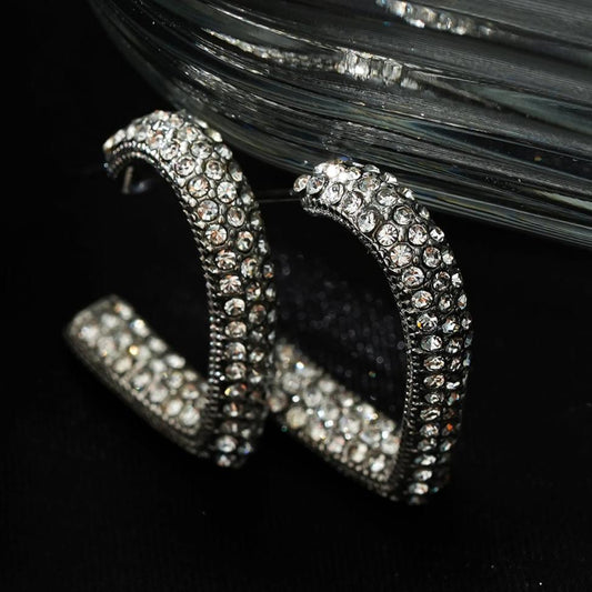 Style ANJAR White Gold (Silver Tone): Heart Shaped Hoops embedded with Zirconia Gemstones