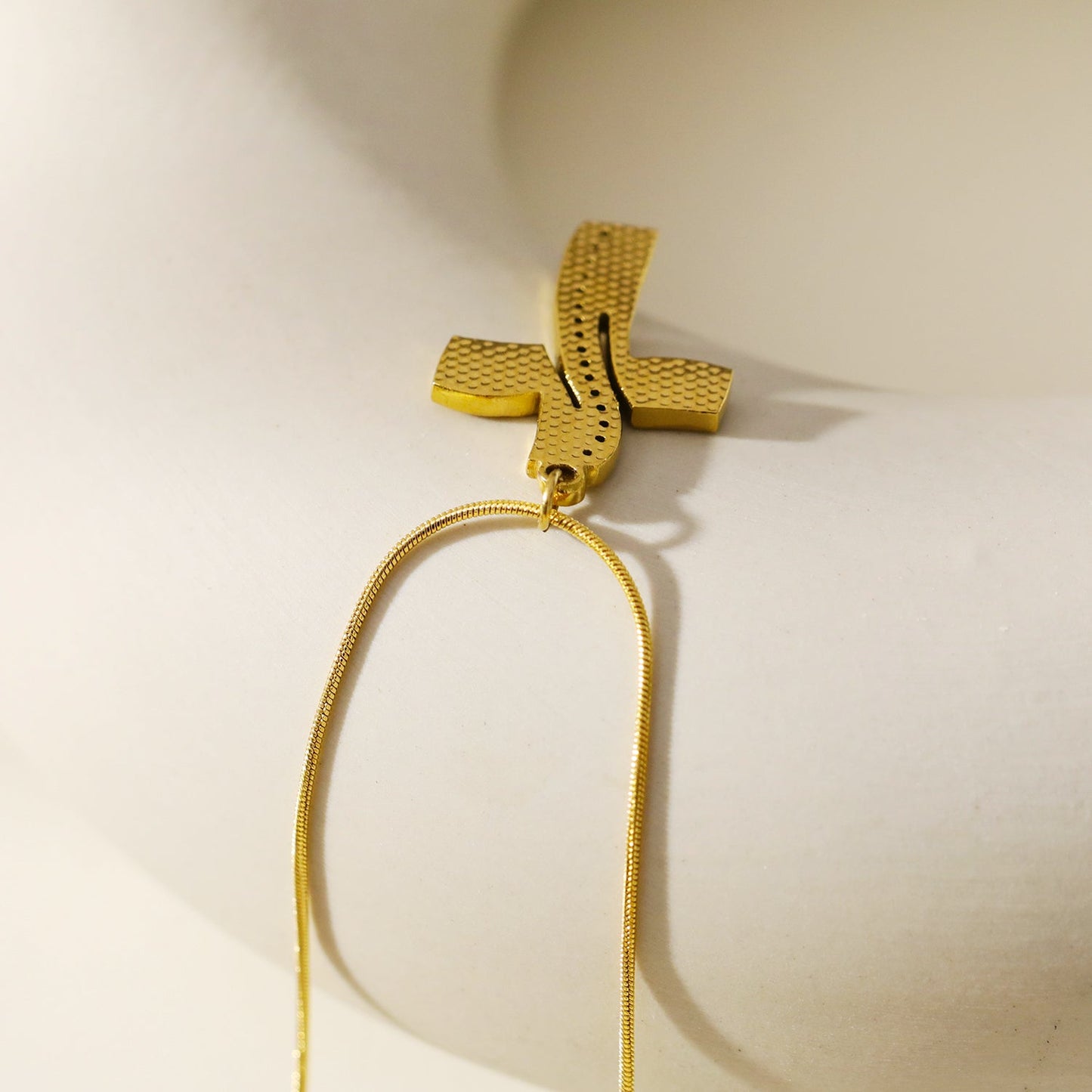 ARCASSA: Zirconia Embedded Hammered Finish Cross Pendant on a Mini Snake Skin Textured Chain Necklace.