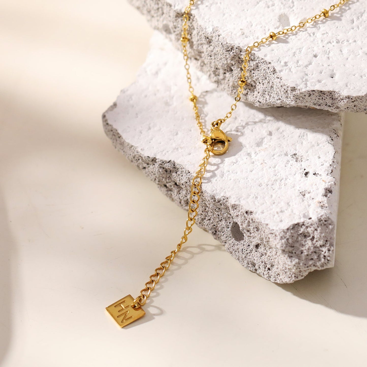 CHAMONIX Gold: Dainty Beaded Chain Necklace with a Zirconia Embedded Textured Cross Pandent