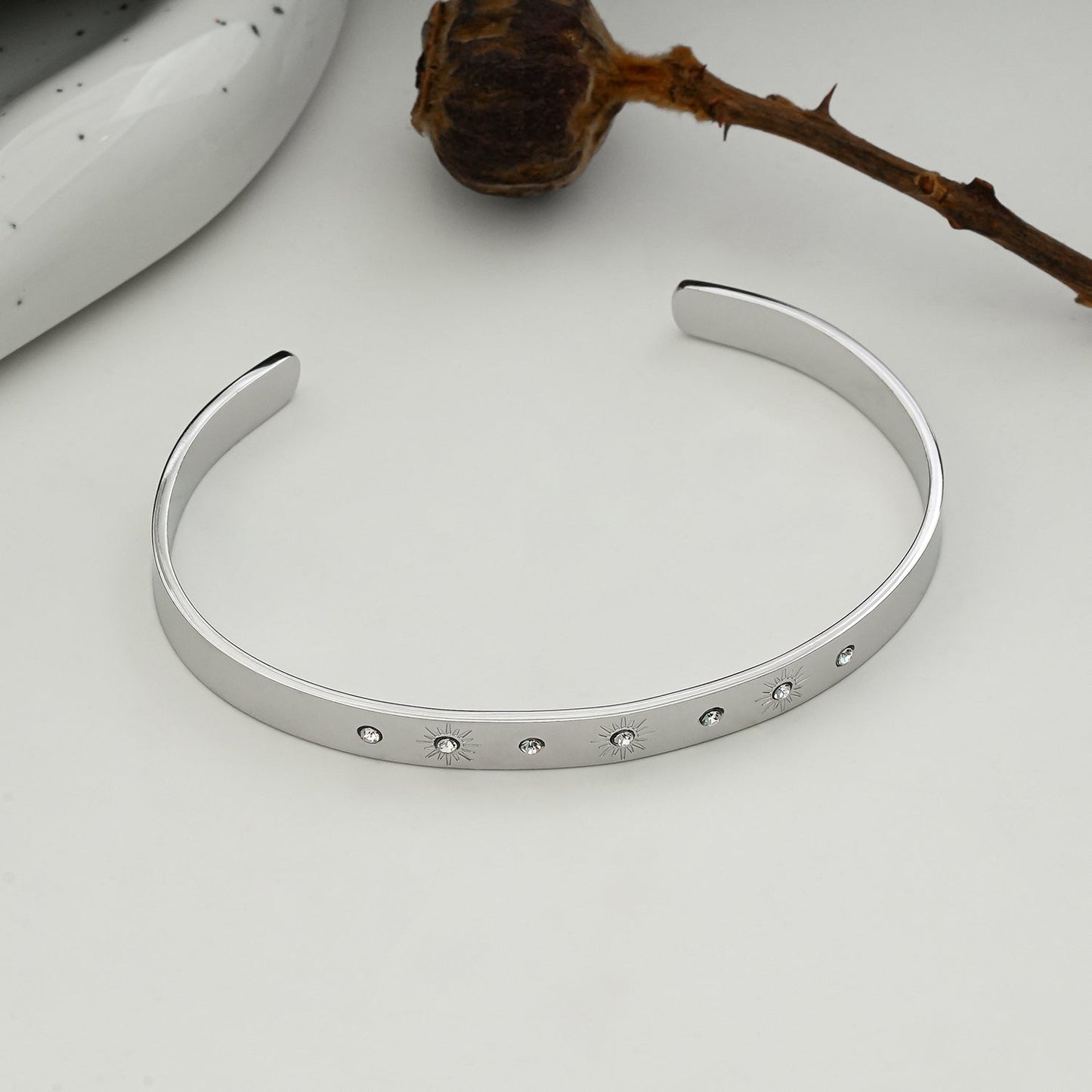 CHIMAKAK: Star-Engraved Zirconia Embedded Band Bracelet in Silver Toned White Gold