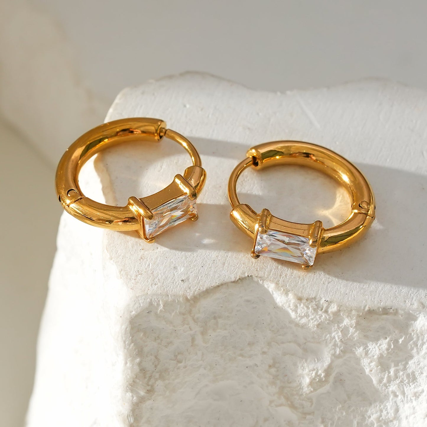 Style CONWYN: Retro Style Hoops with an Encased Clear Zirconia Charm in Gold.