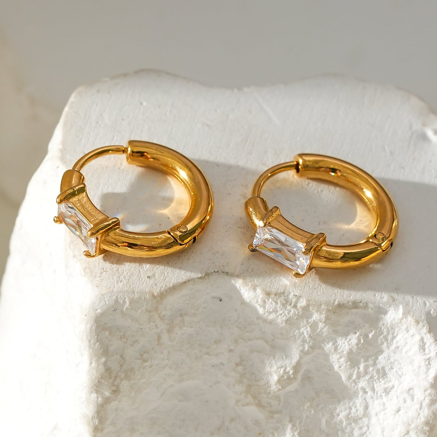 Style CONWYN: Retro Style Hoops with an Encased Clear Zirconia Charm in Gold.