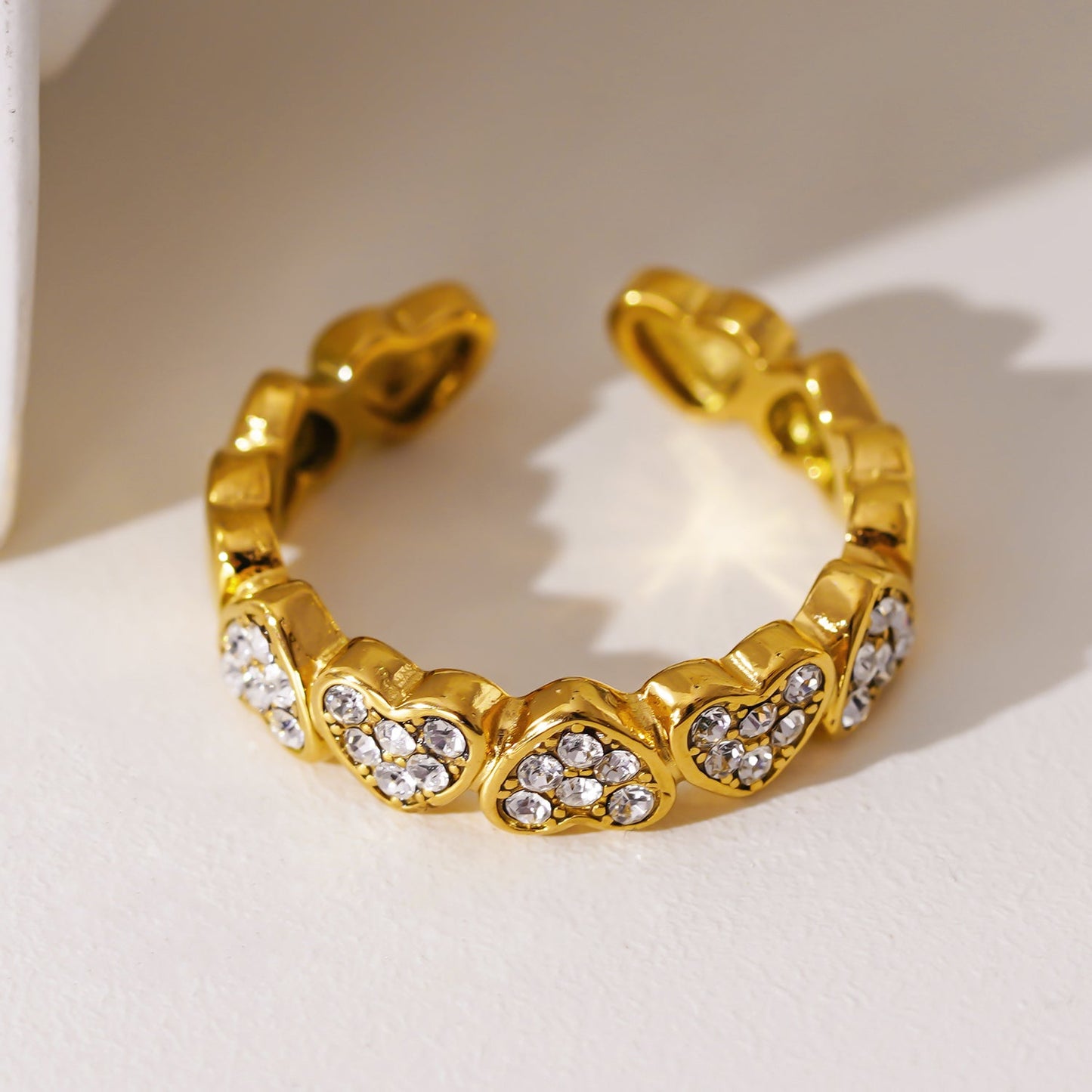 JEZREEL: Heart-Shaped Mini Charms Encircled Ring With Zirconia Crystal Centre Pieces