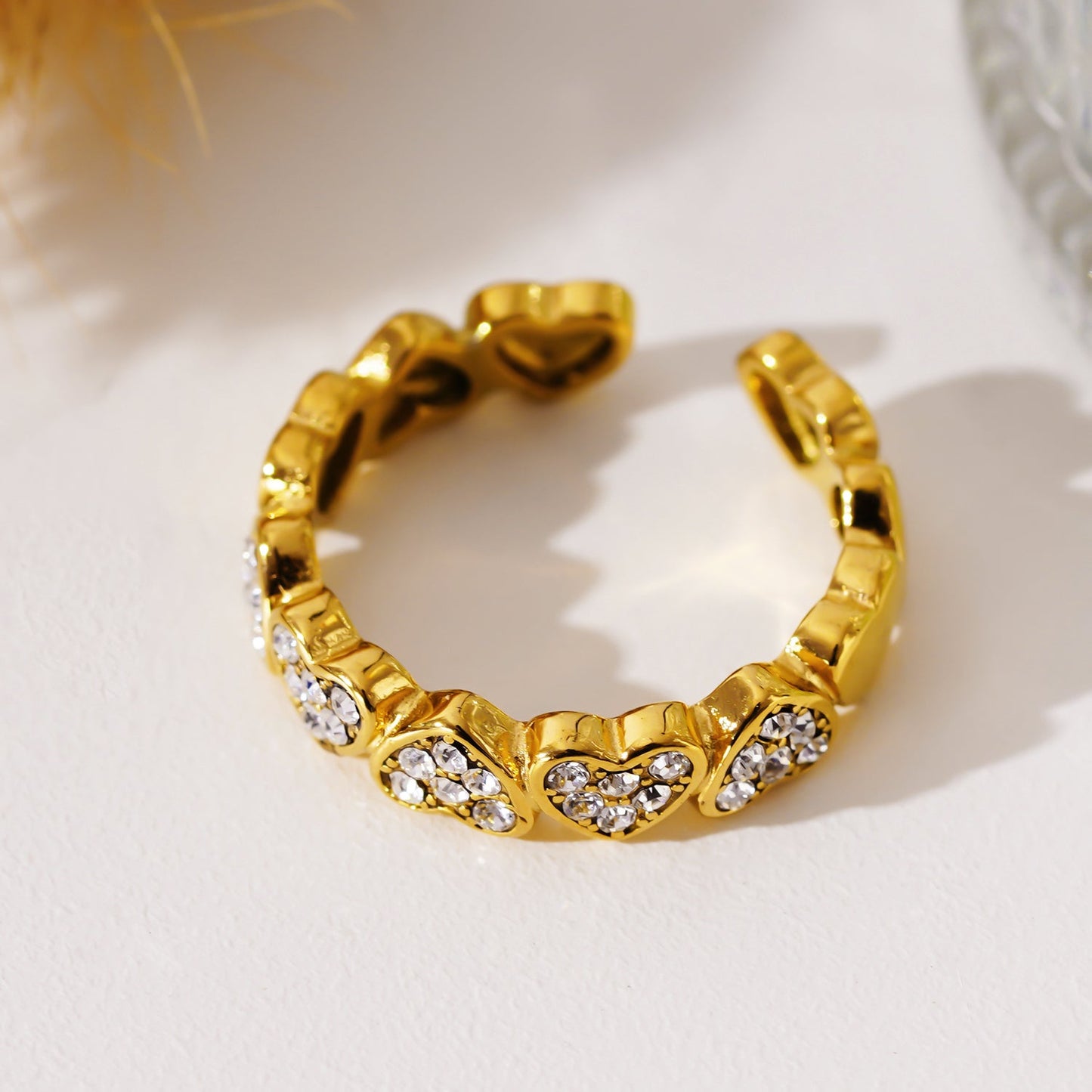 JEZREEL: Heart-Shaped Mini Charms Encircled Ring With Zirconia Crystal Centre Pieces