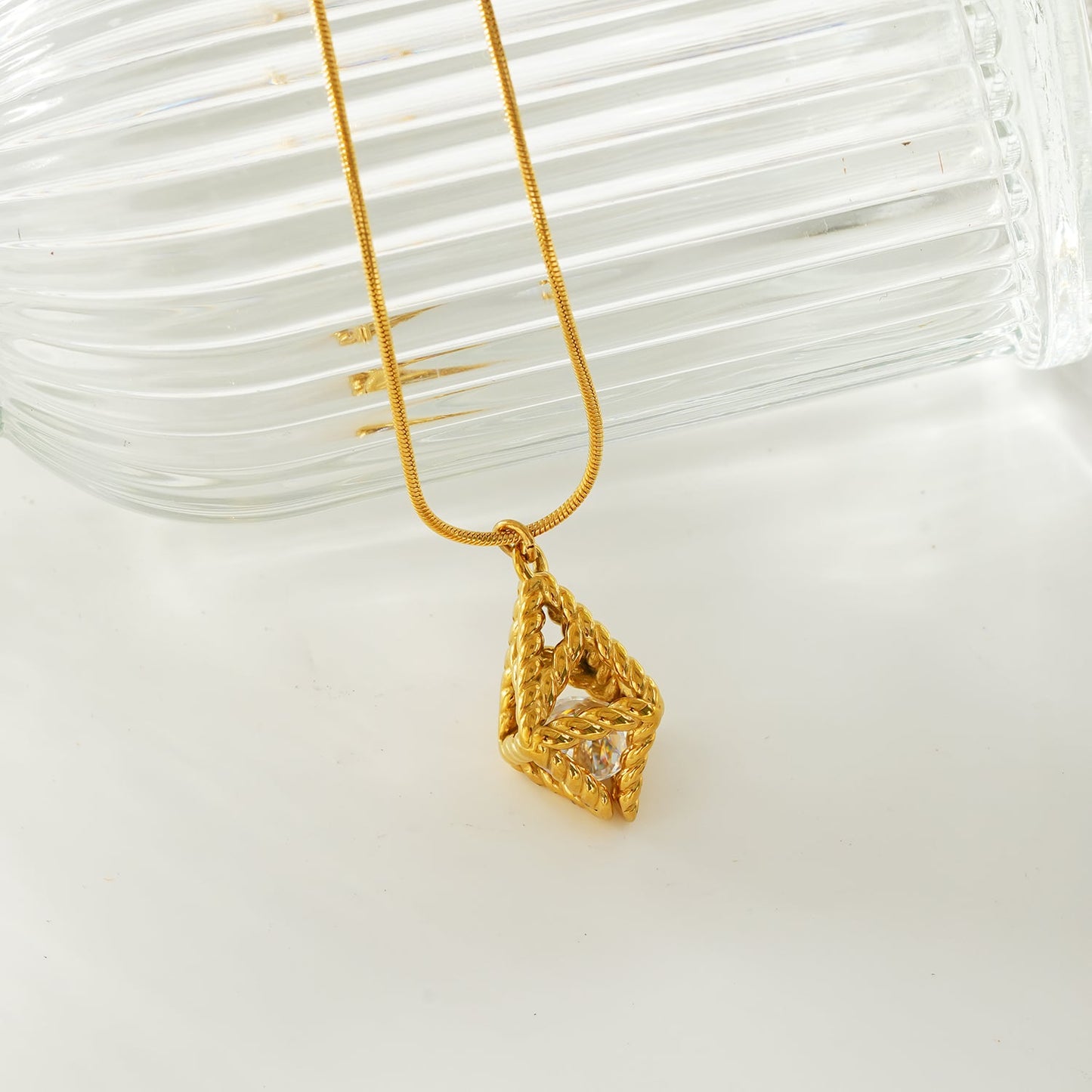 Style KARJAT: Gold Chain Necklace with Geometric Caged Zirconia Pendant
