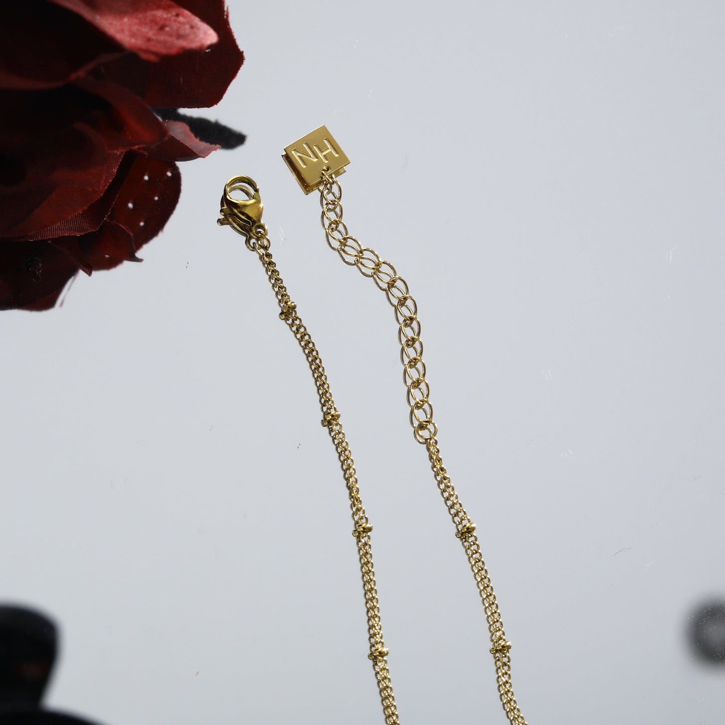 LERATI: Beaded Chain with an Encased Fresh Water Pearl Pendant in Gold