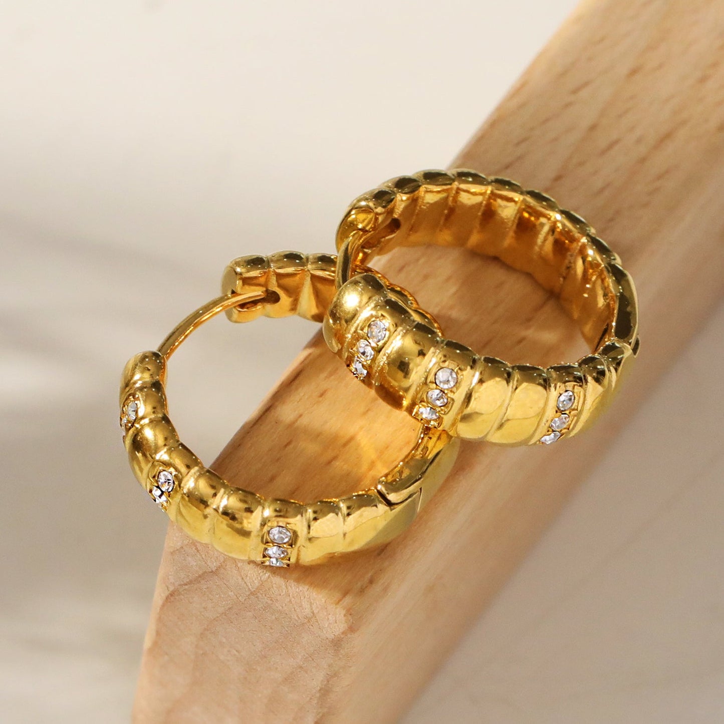 LIZBETH: Sculpted Hoop Earrings with Zirconia Embellishments.