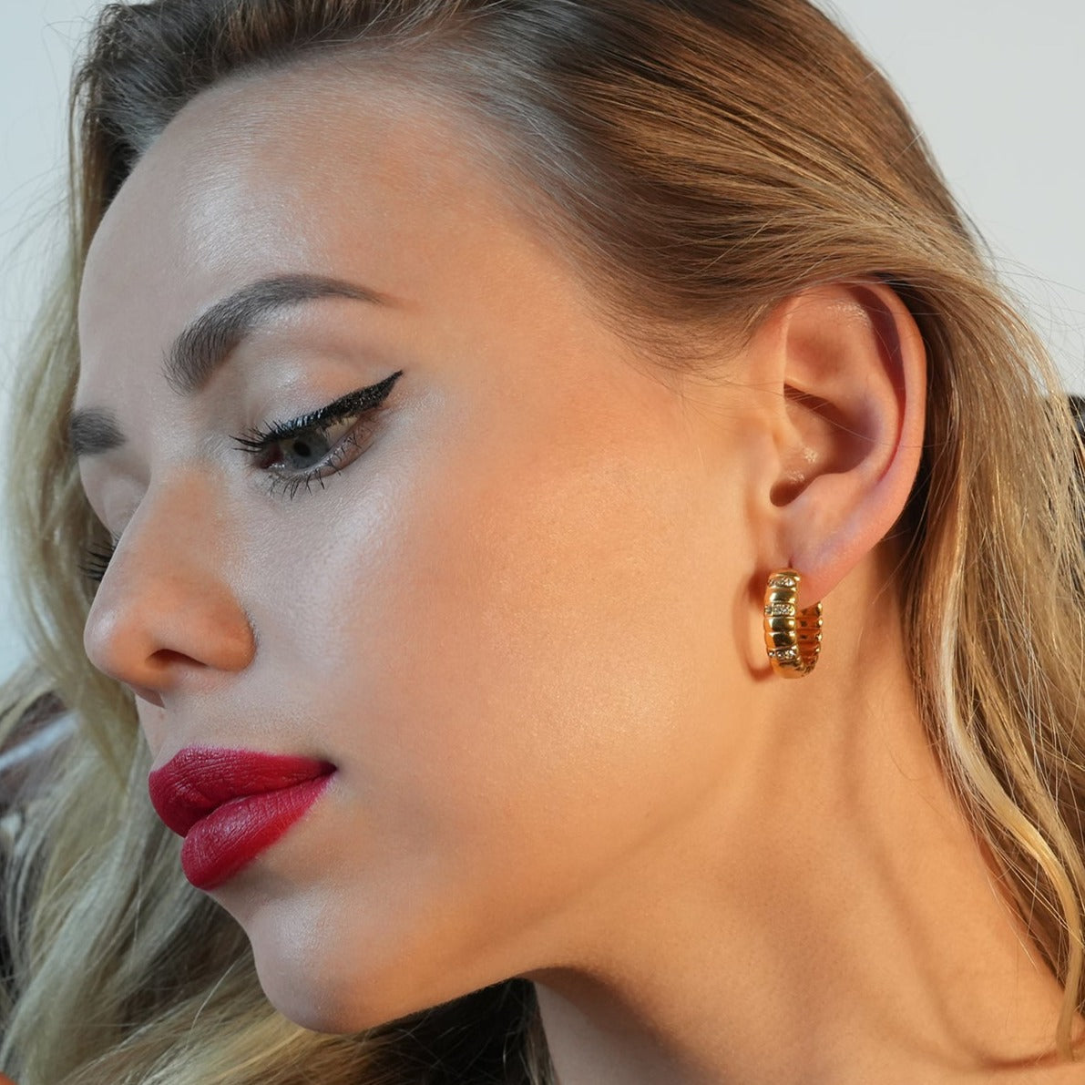 LIZBETH: Sculpted Hoop Earrings with Zirconia Embellishments.