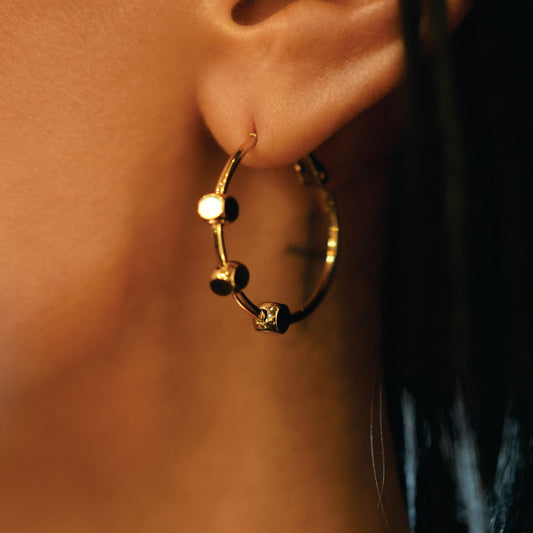 MASUYO: Avant-Garde Rounded Hoop Earrings Anchoring a Trio of Square Beads.