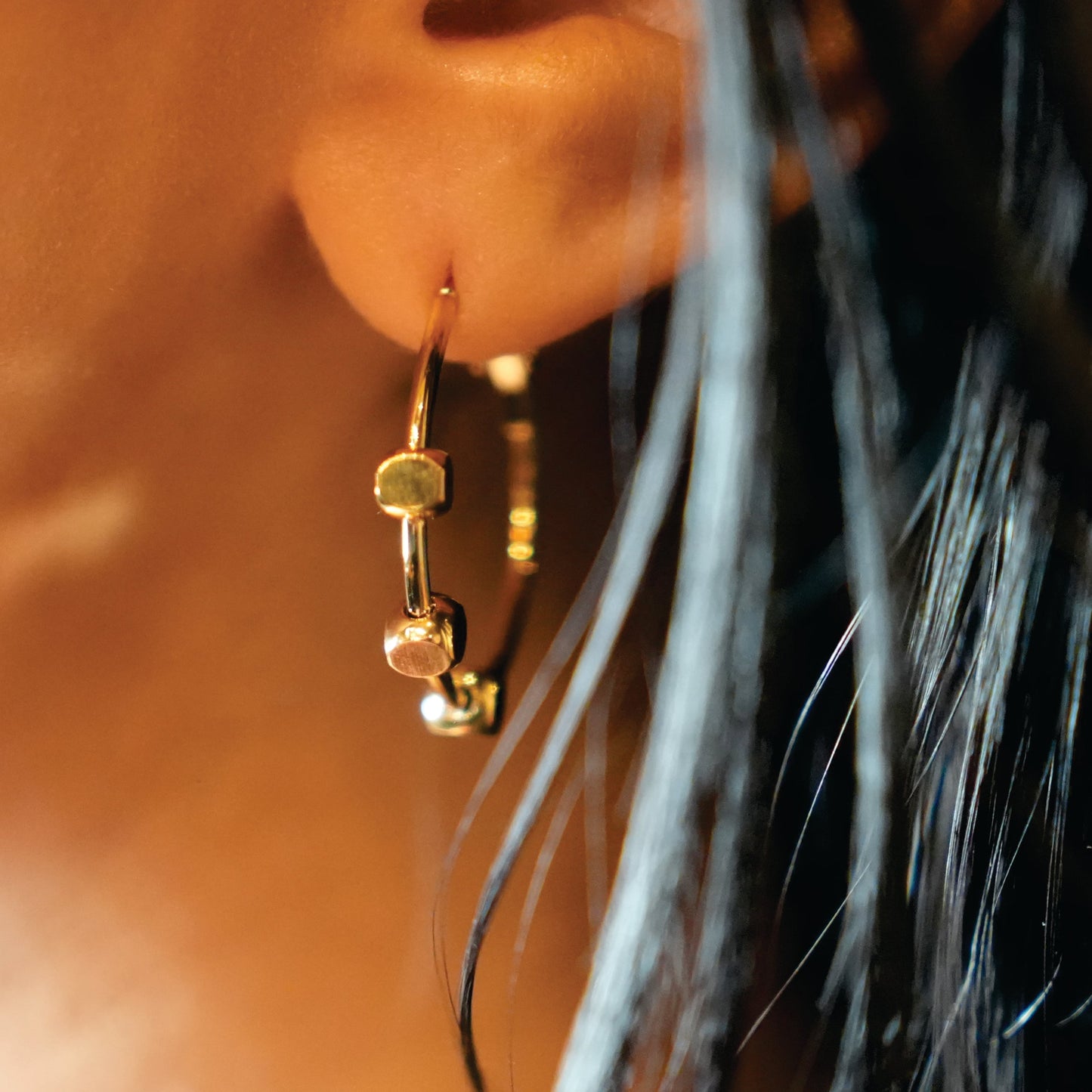 MASUYO: Avant-Garde Rounded Hoop Earrings Anchoring a Trio of Square Beads.