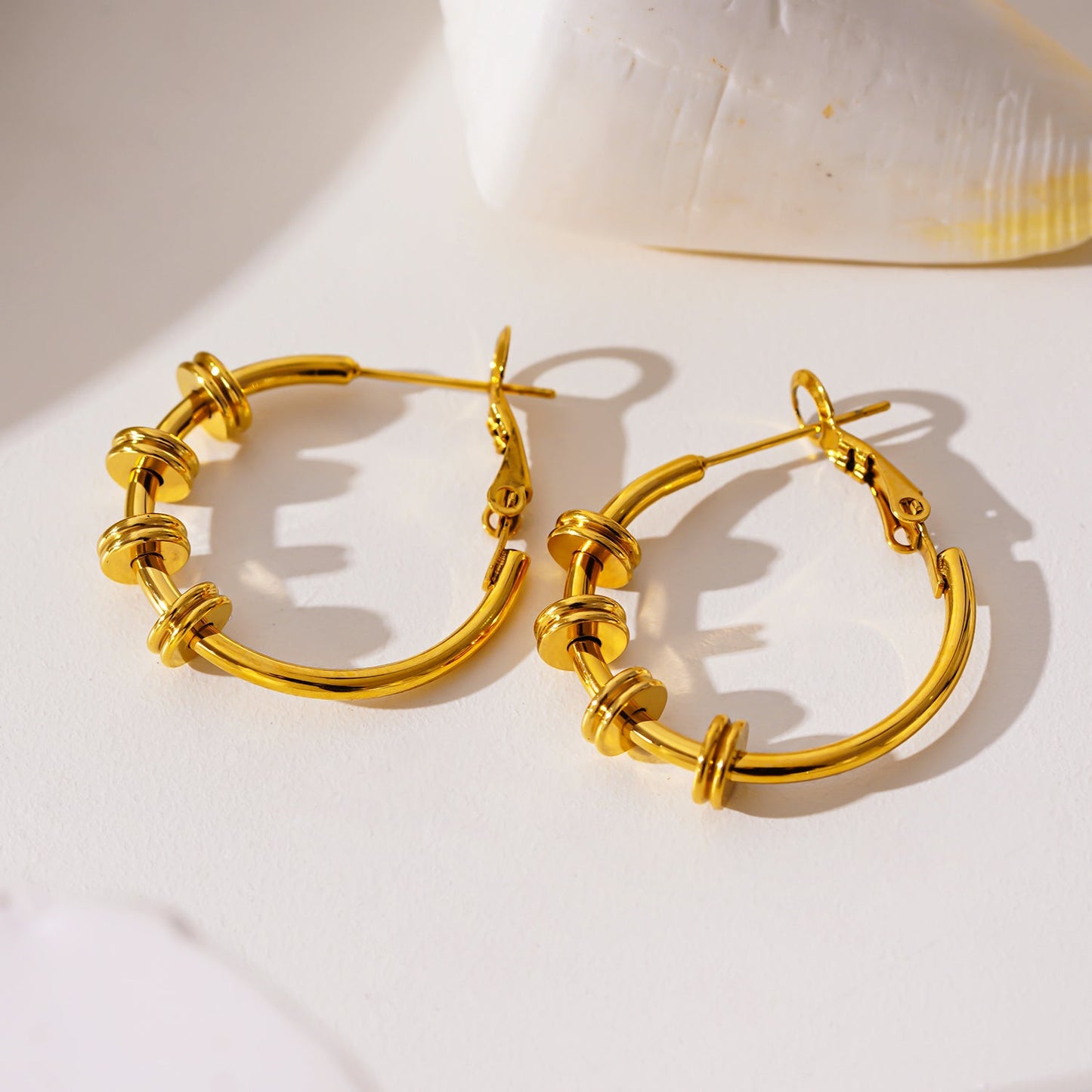 MINATO: Modernist Hoop Earrings Anchoring Industrial-Chic Double Discs.