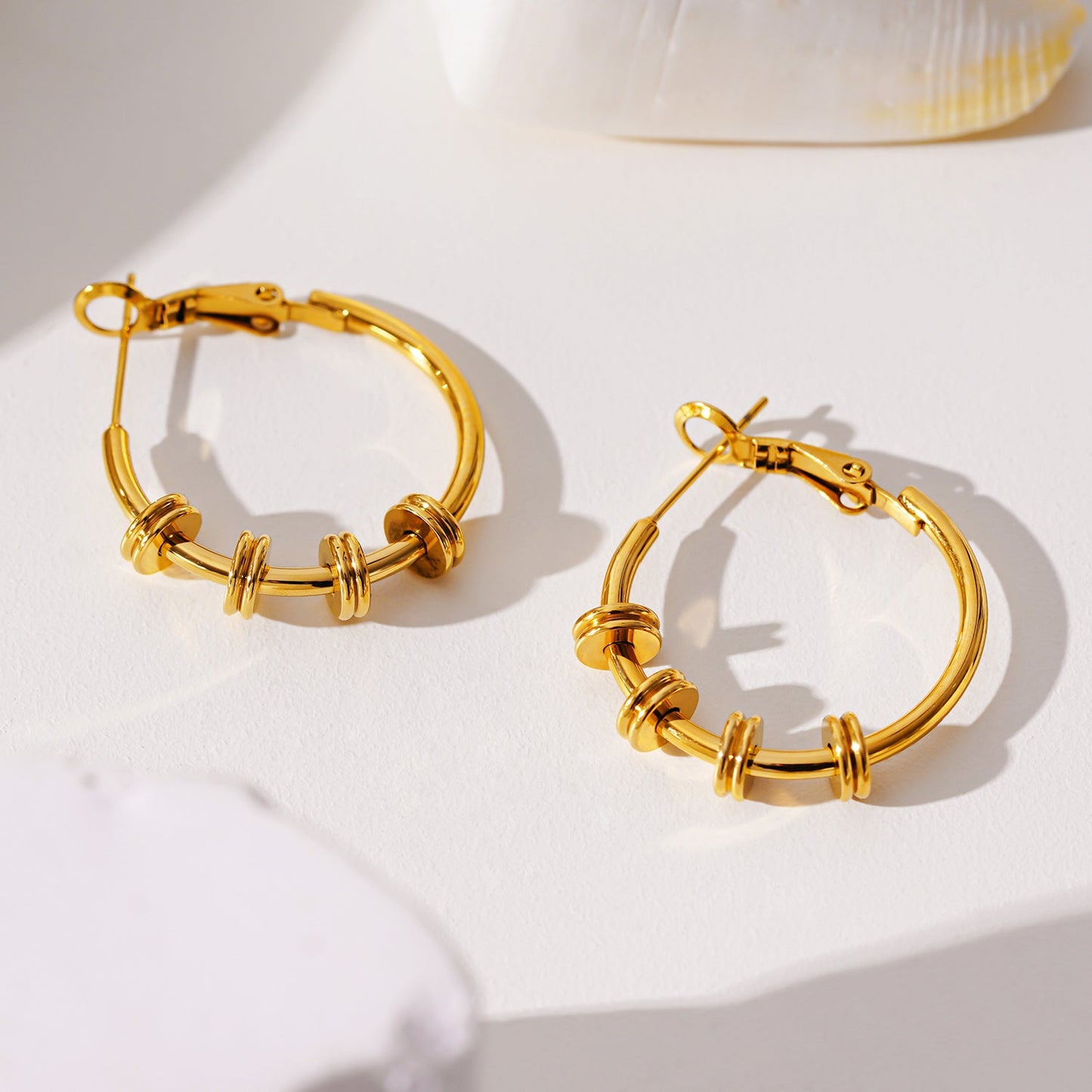 MINATO: Modernist Hoop Earrings Anchoring Industrial-Chic Double Discs.