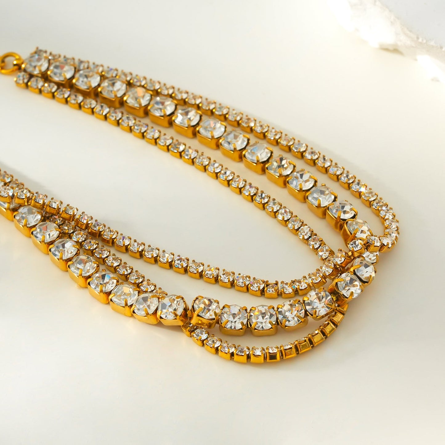 NANDAMA Gold: Triple Layered - Three-Row Zirconia (CZ) Tennis Bracelet with Bold Centerpiece. Stacked for Glamour.