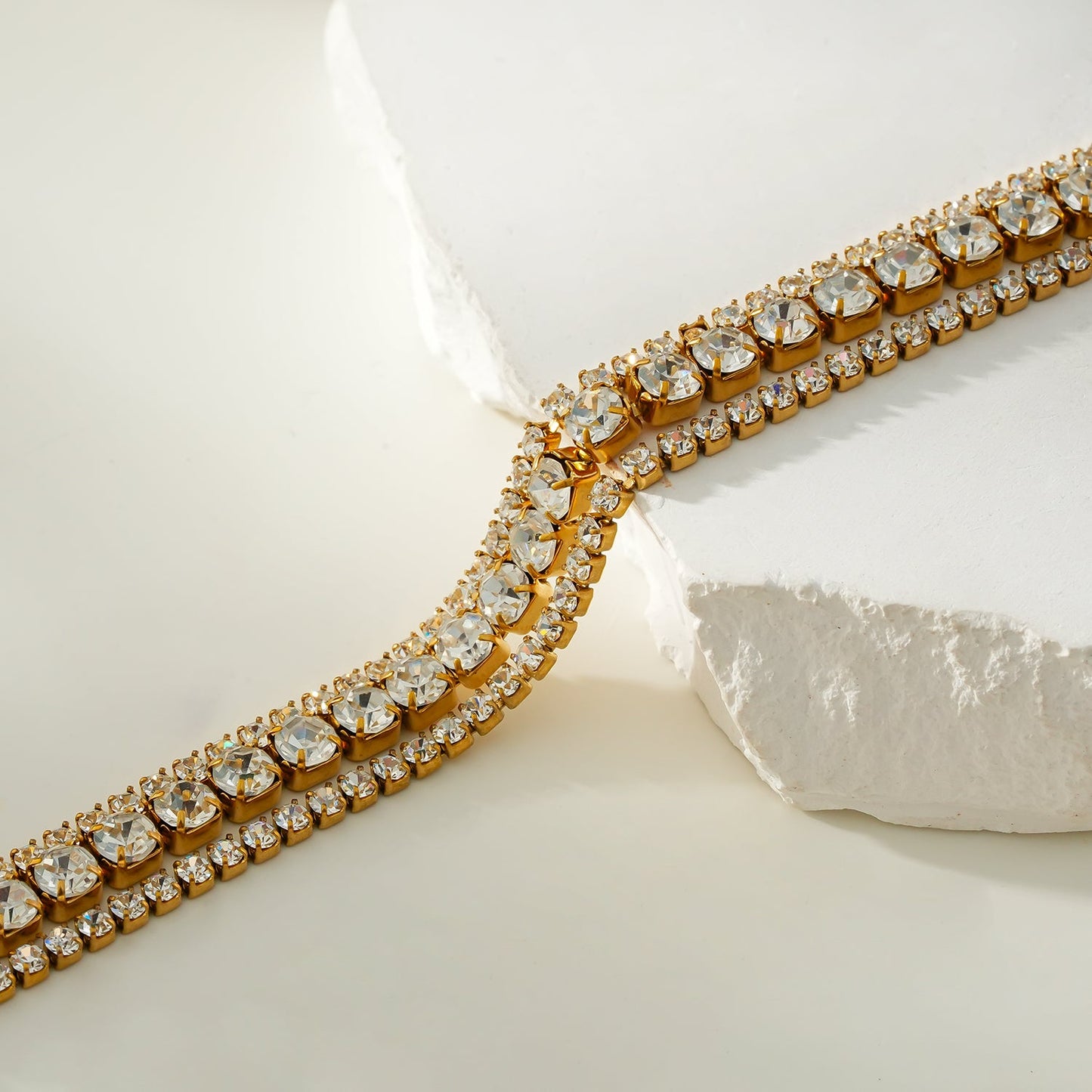 NANDAMA Gold: Triple Layered - Three-Row Zirconia (CZ) Tennis Bracelet with Bold Centerpiece. Stacked for Glamour.
