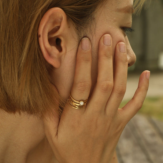 NADIA Gold: Multi Stacked Ring with a Stone Centre Piece