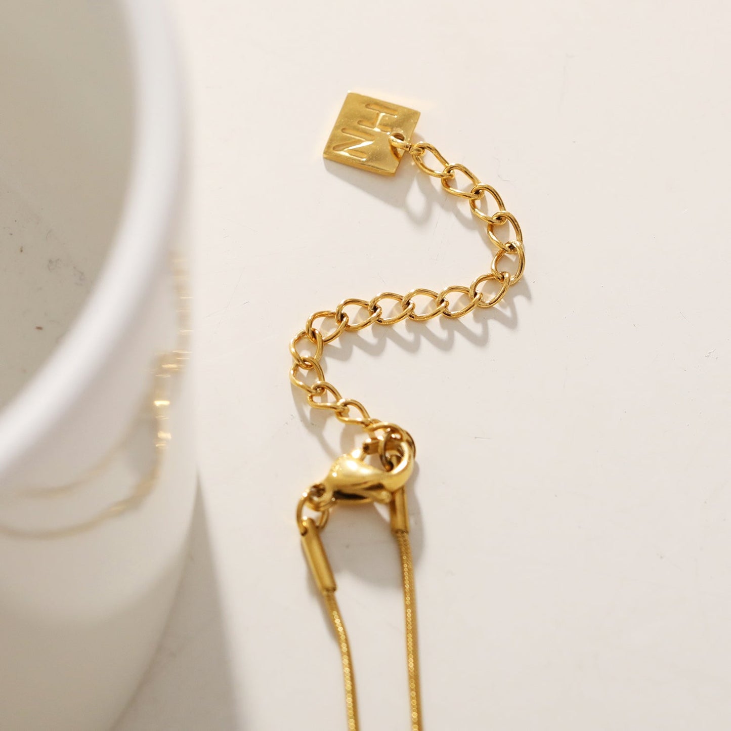 Style DEFNIE: Snake-Skin textured Dainty Chain Necklace Anchoring a Trio of Charms