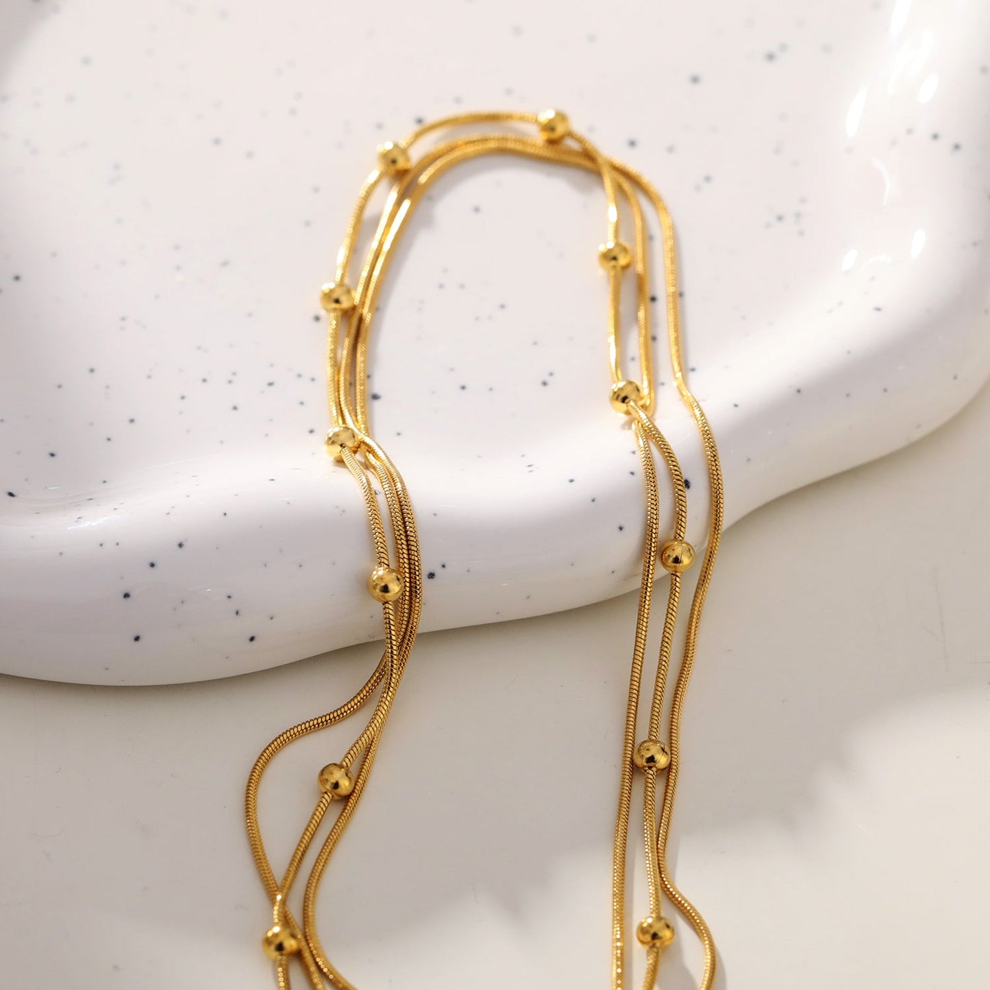 KAKIA: Triple Snake-Skin Chain Layered Necklace with Ball-Bead Accents