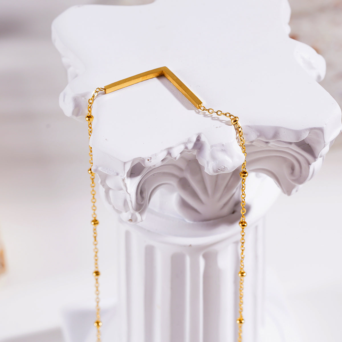 SANITA: Beaded Dainty Chain Anchoring 'V' Shaped Zirconia Embedded Pendant Charm