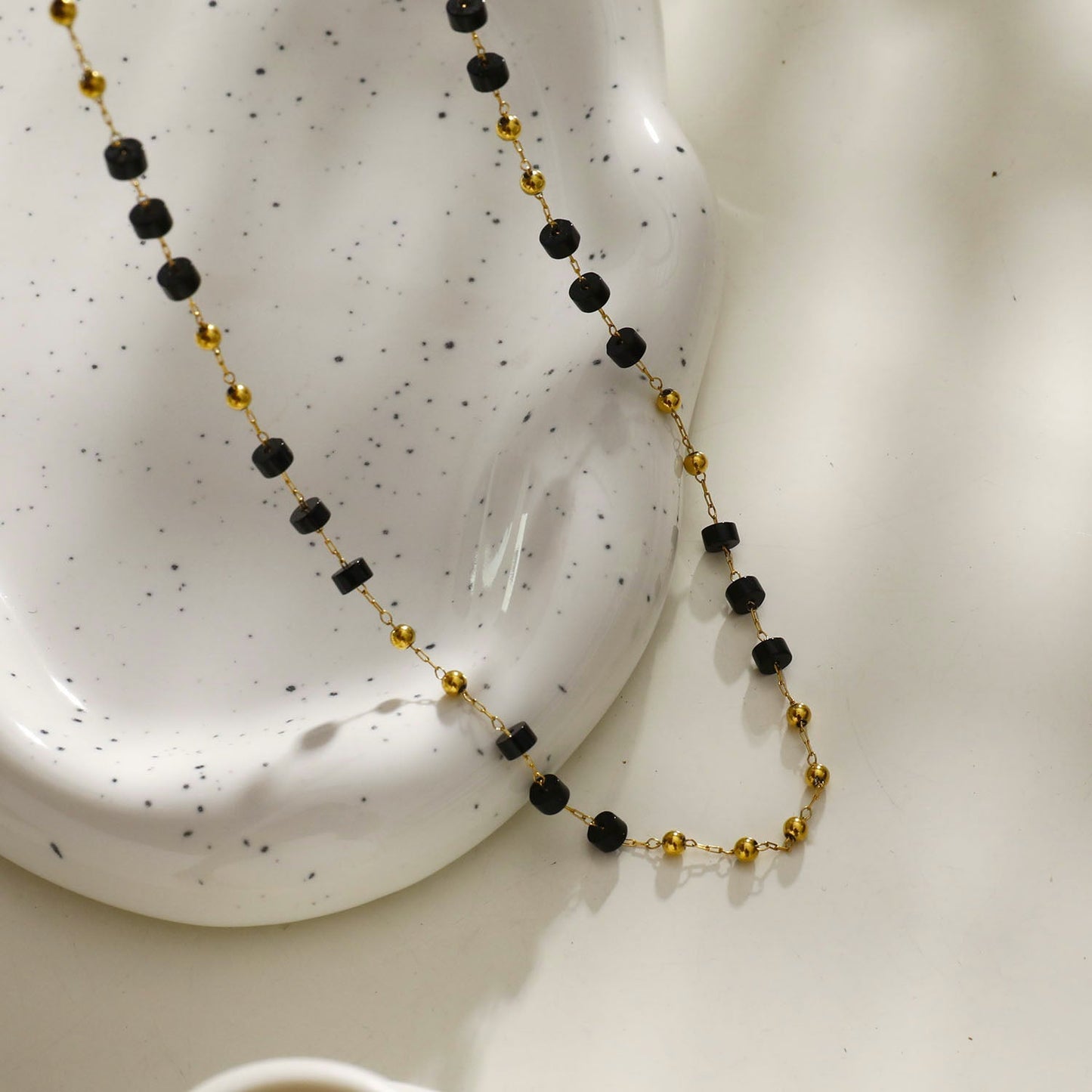 SANTA CRUZ Black: Gold & Black Onyx Beaded Chain Necklace