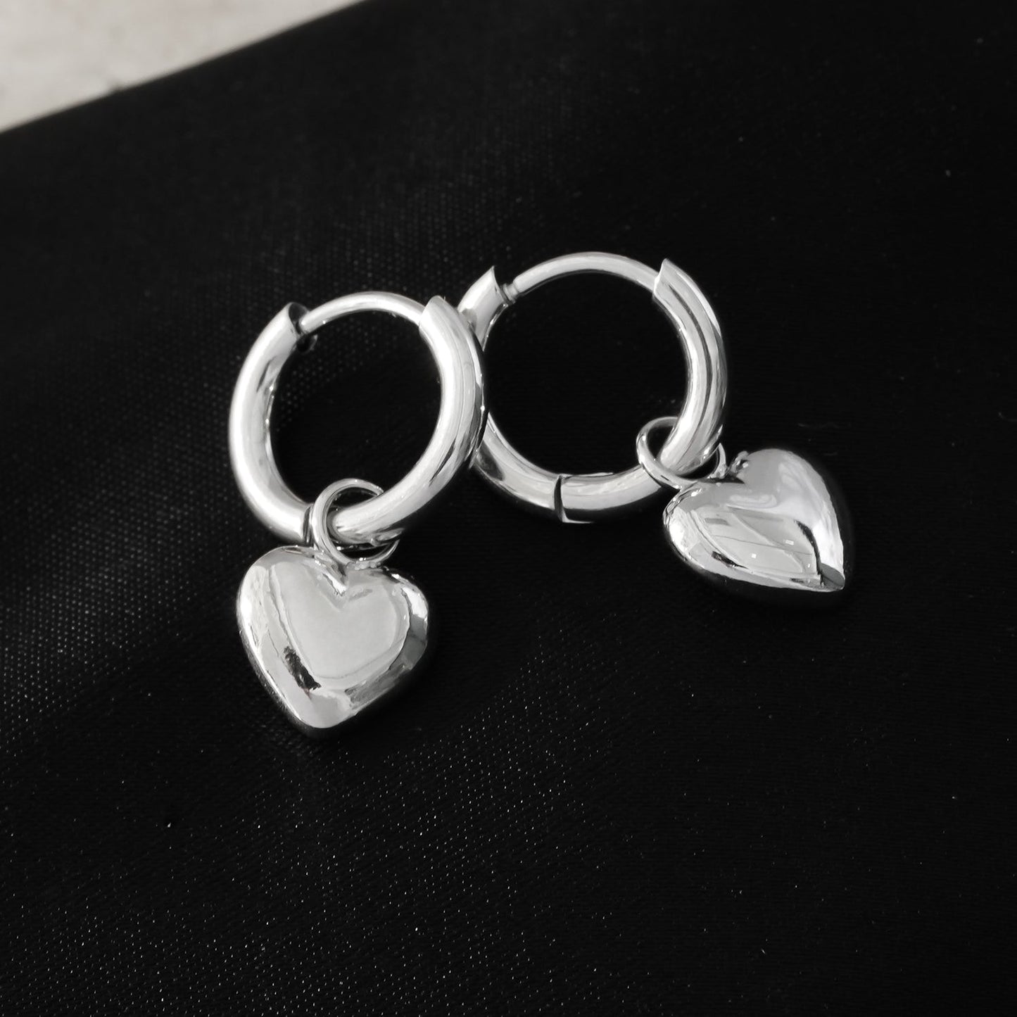 STOWE Silver: Mini Hoop Earrings Anchoring a Heart Shaped Charm